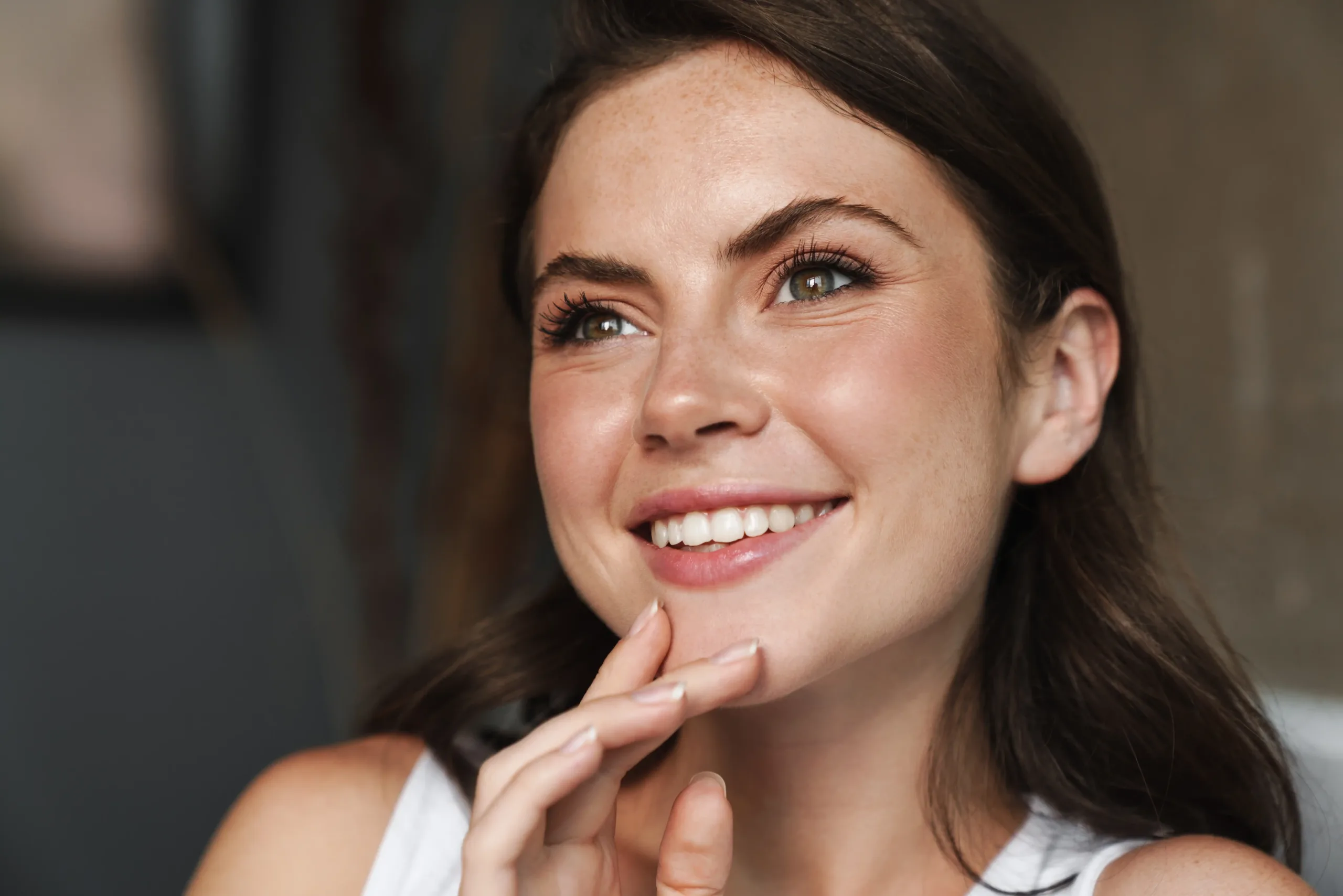 A woman smiling widely showing off her teeth