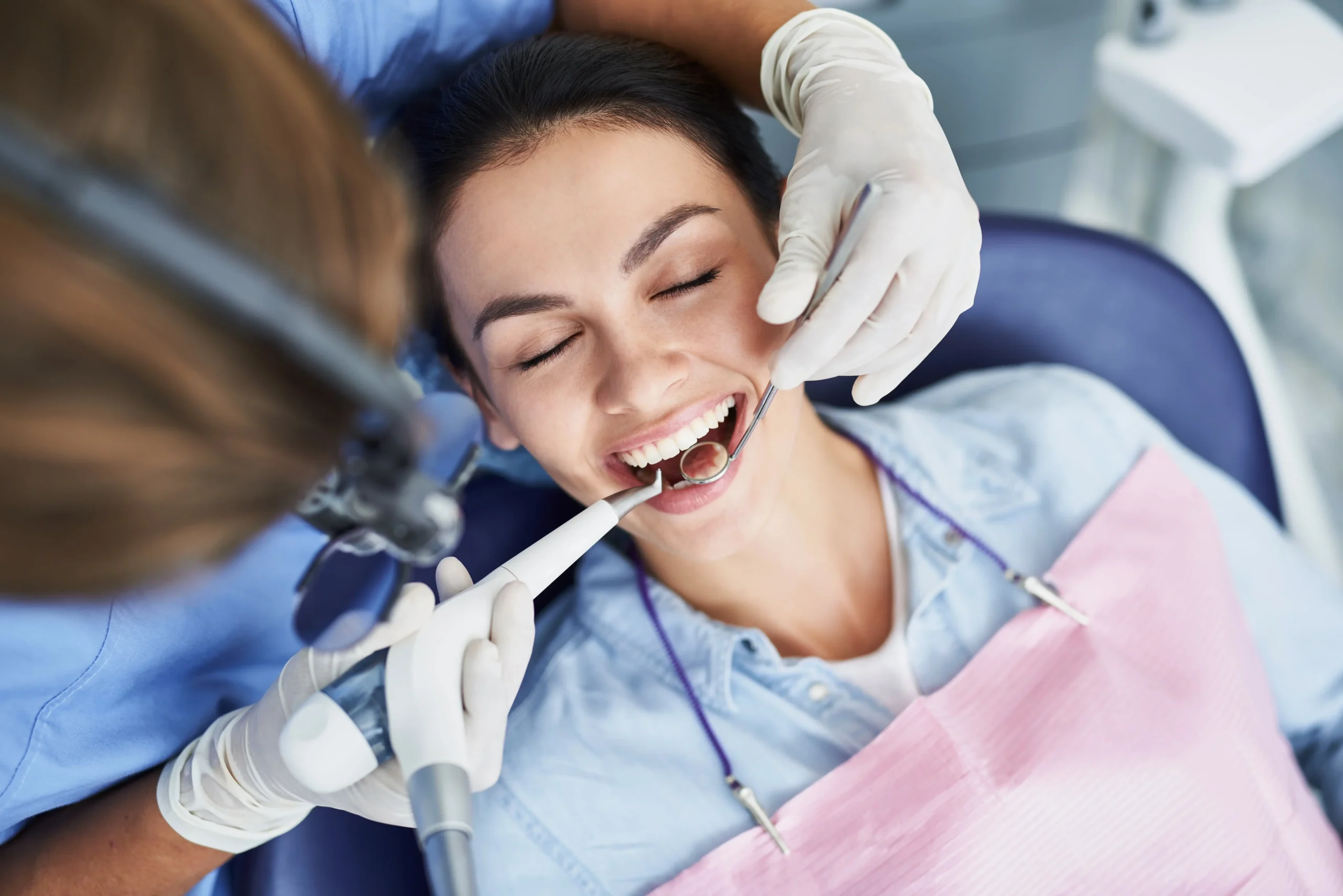 Woman at the dentist getting her teeth cleaned